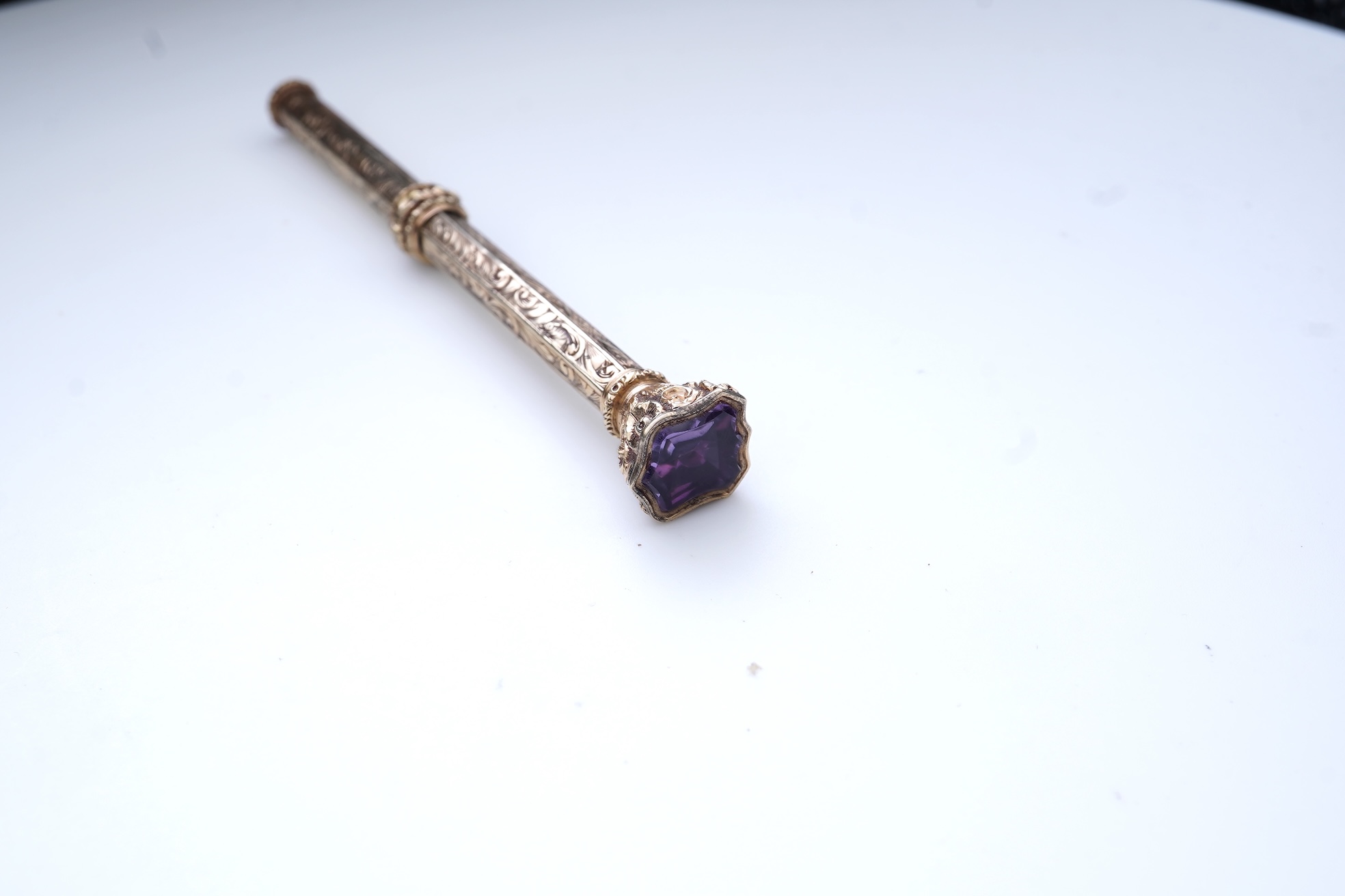 An early Victorian gold and amethyst mechanical pencil, mid 19th century